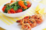 A light, healthy salad with barbecued prawn kebabs